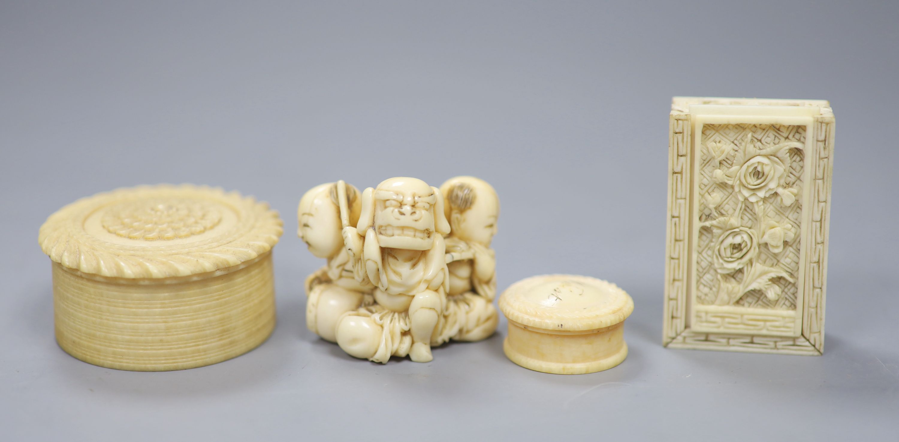 A 19th century Cantonese export carved ivory whist box, with a sliding floral panelled cover, and contents, 5 x 3.5cm together with a